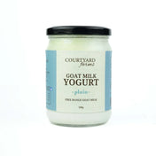 Jar of Courtyard Farms goat milk yogurt on a white background